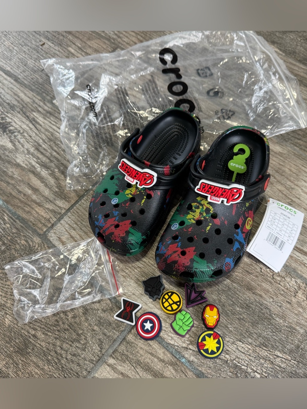 Brand New CROCS Kids Black Multi Marvel Paint-Splash Clogs with Charms (Size J1)